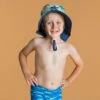 Chapeau Anti UV Bébé Réversible Bleu Et Imprimé Palmiers -Magasin De Matériel De Surf chapeau anti uv bebe reversible bleu et imprime palmiers